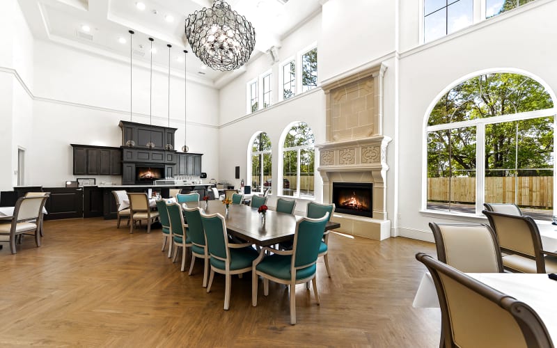 Upscale dining room with large windows, high ceilings, and a fireplace at The Blake at LPGA in Daytona Beach, Florida