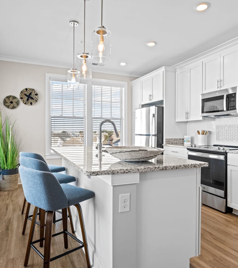 Beautiful kitchen with island at Village Square Apartments in Norfolk, Virginia