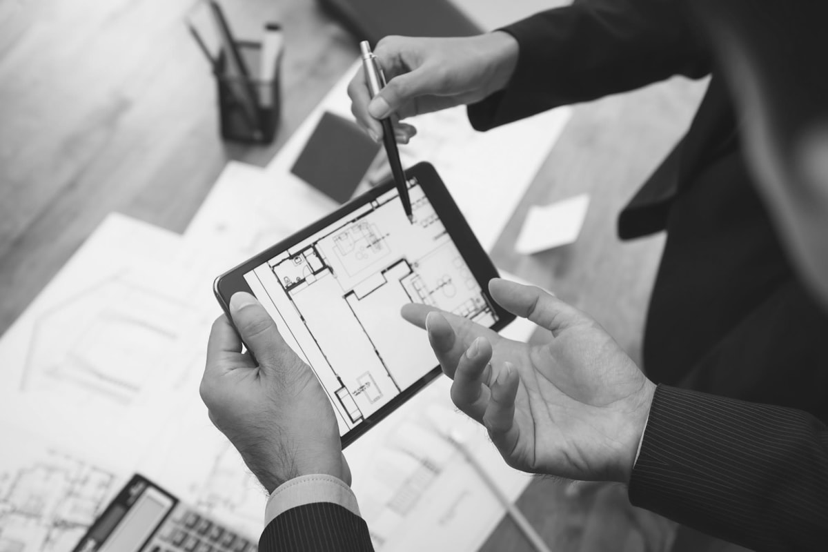 corporate workers around a tablet at American Property Management in Bellevue, Washington 