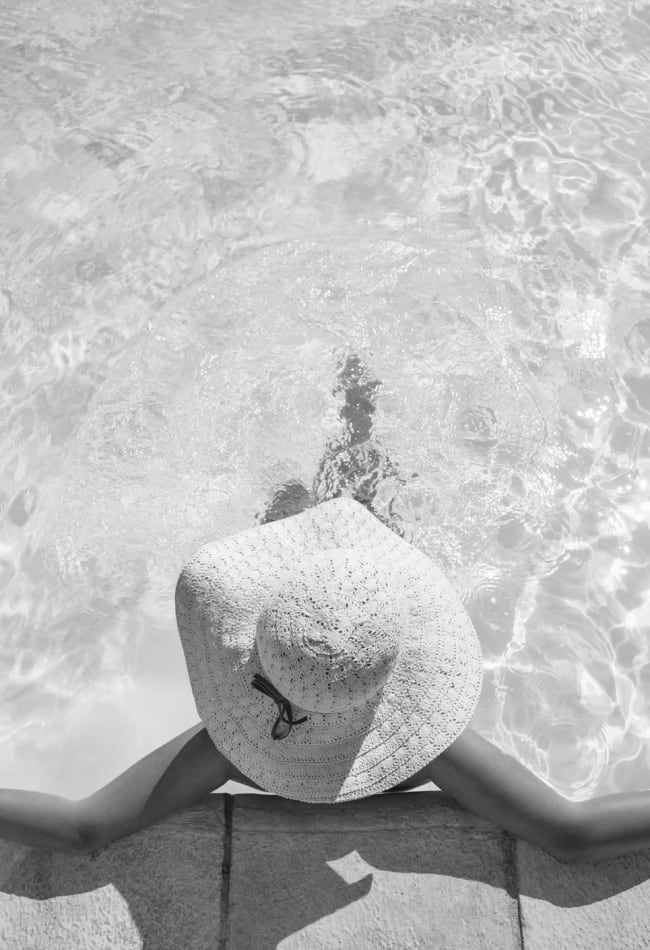 Woman relaxing in the pool at Inscription West Palm Beach in West Palm Beach, Florida