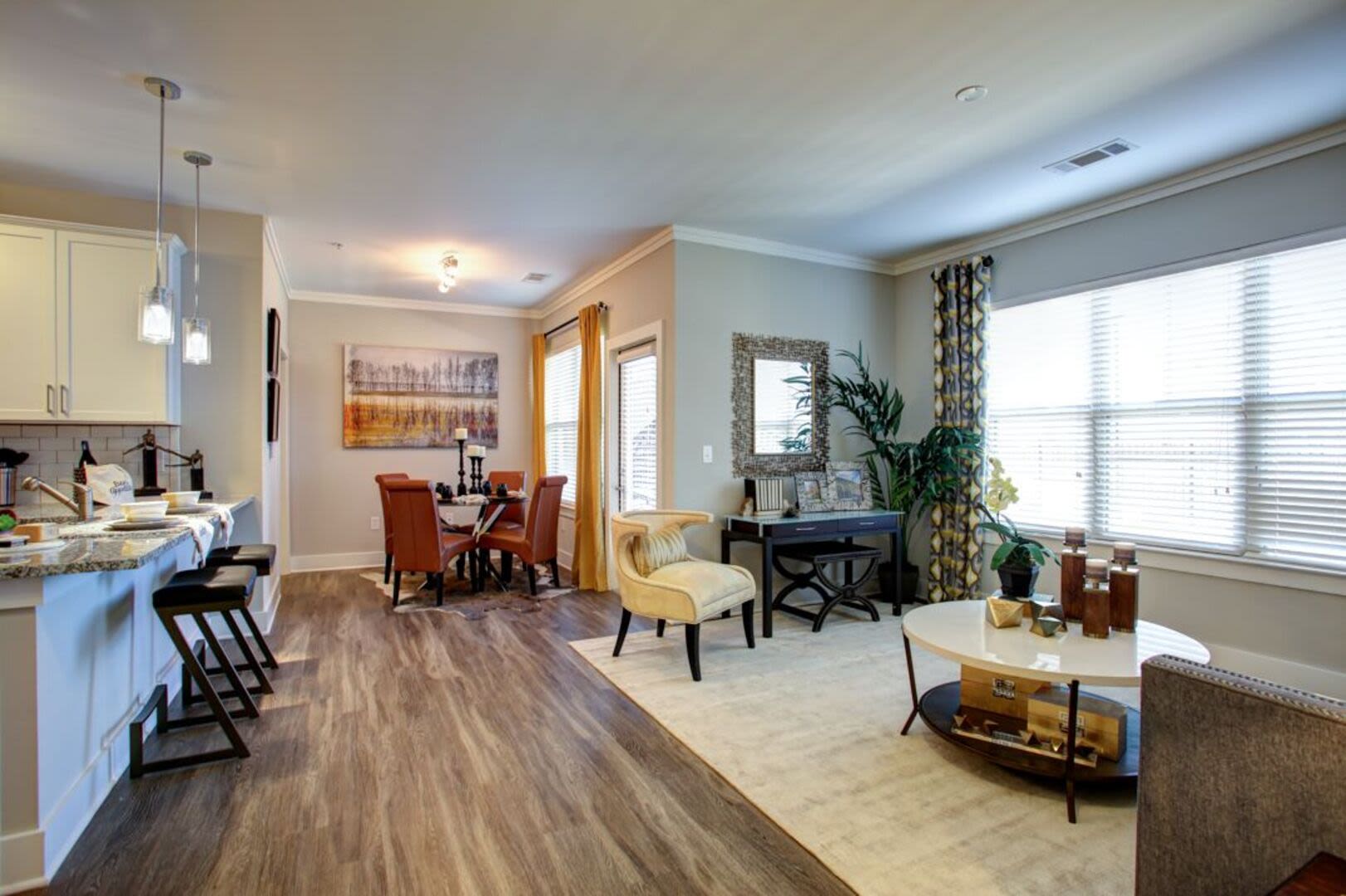 Living space with orange accents and wood flooring Avonlea Creekside in Marietta, Georgia