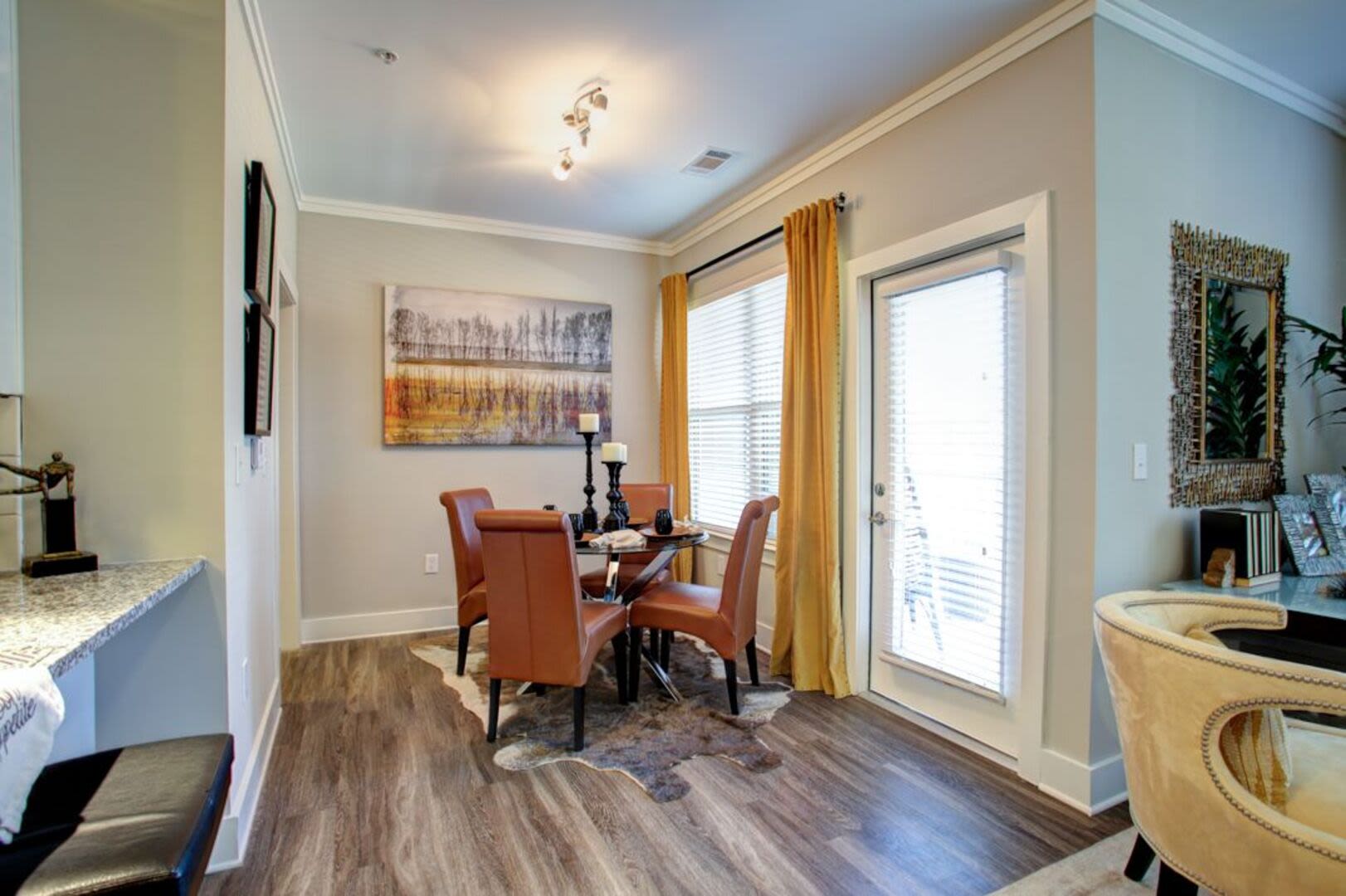 Model dining area with wood flooring Avonlea Creekside in Marietta, Georgia
