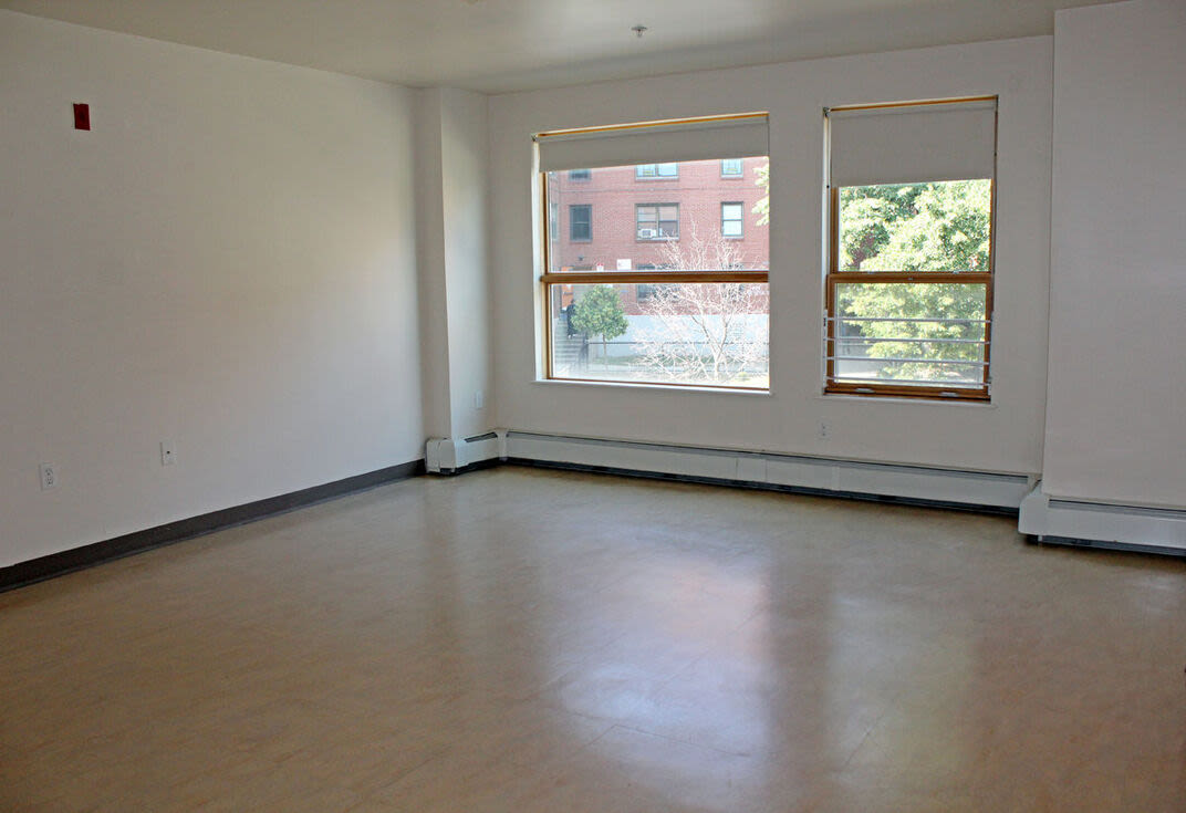 Spacious living room with windows at 270 Centre Street in Jamaica Plain, Massachusetts
