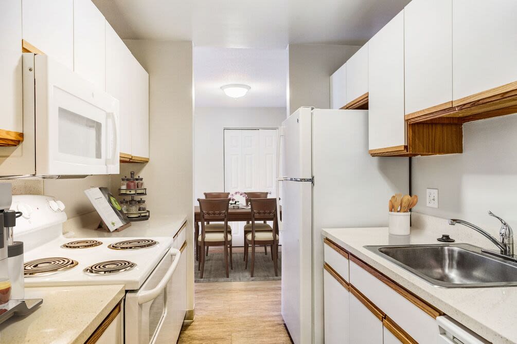 Kitchen with granite countertops stainless steel appliances like a refrigerator, stove, and drawer microwave at 840 County in Taunton, Massachusetts