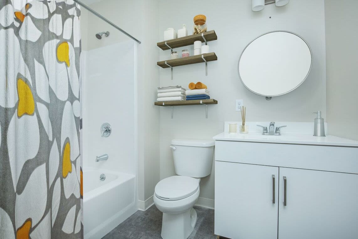 Bathroom with mirror, commode and bathtub at 98 Essex in Haverhill, Massachusetts