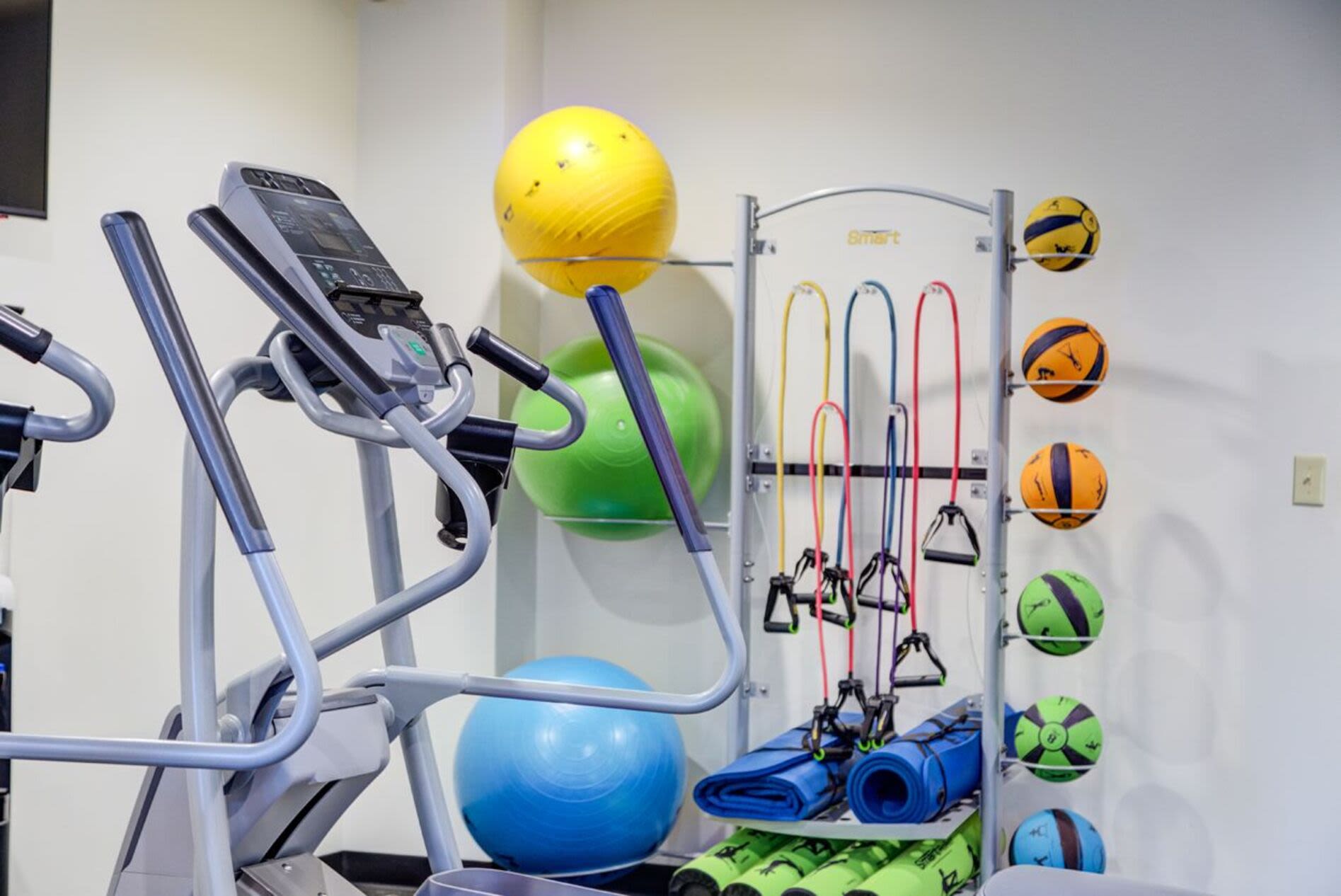 Fitness center with treadmill and multiple weights at Anchors Weigh in Chelsea, Massachusetts