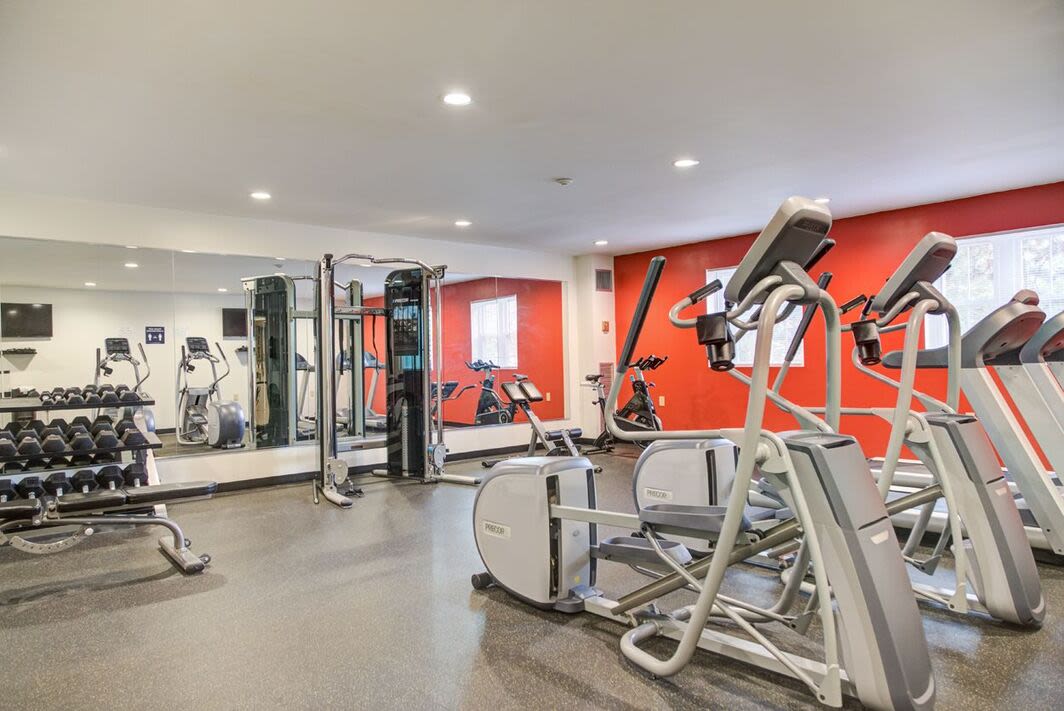 Well-equipped fitness center with large mirror at Anchors Weigh in Chelsea, Massachusetts