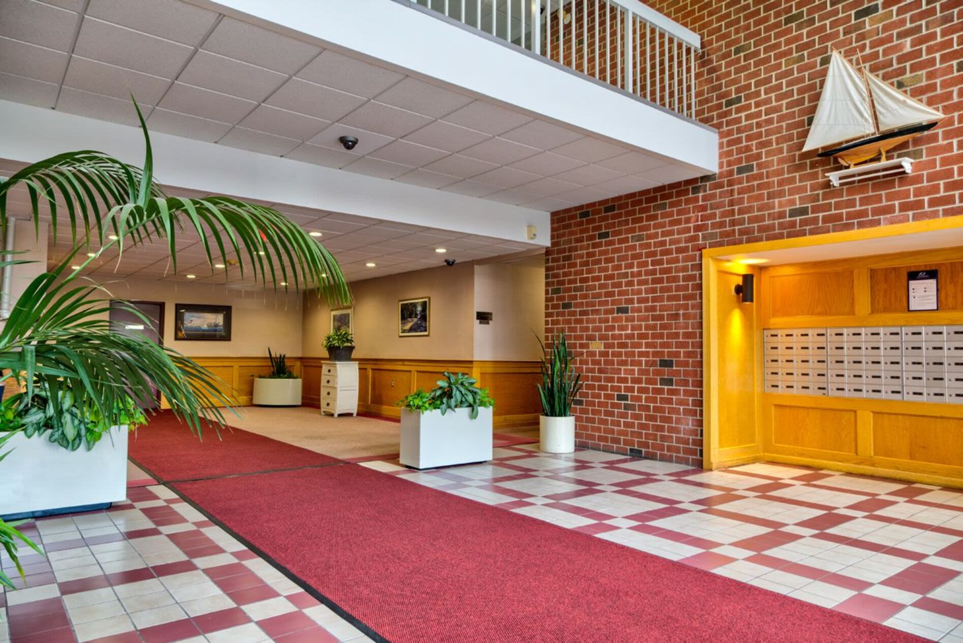 Entrance of the apartment building with a red carpet at Anchors Weigh in Chelsea, Massachusetts