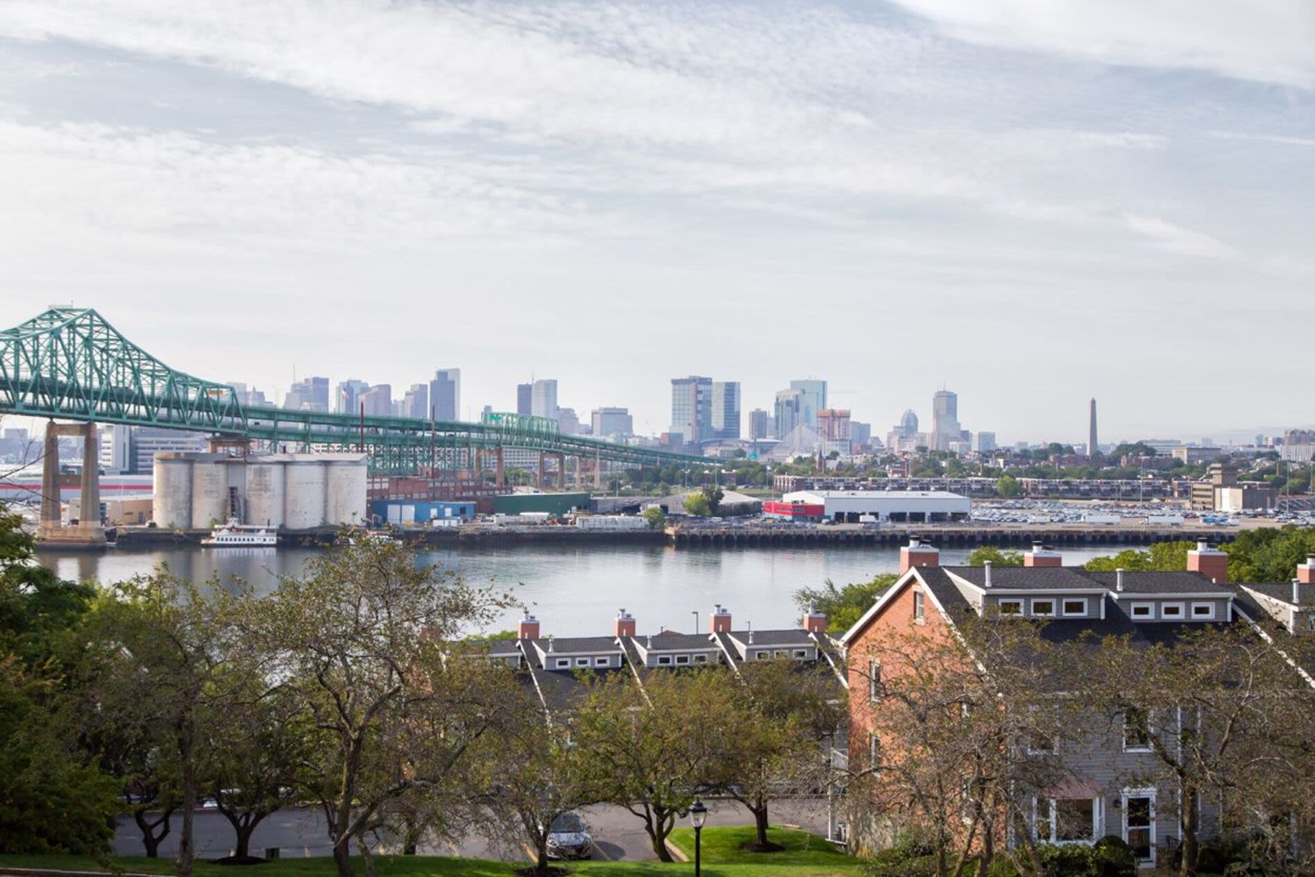 View of the city across the river, with a bridge in the foreground at Anchors Weigh in Chelsea, Massachusetts