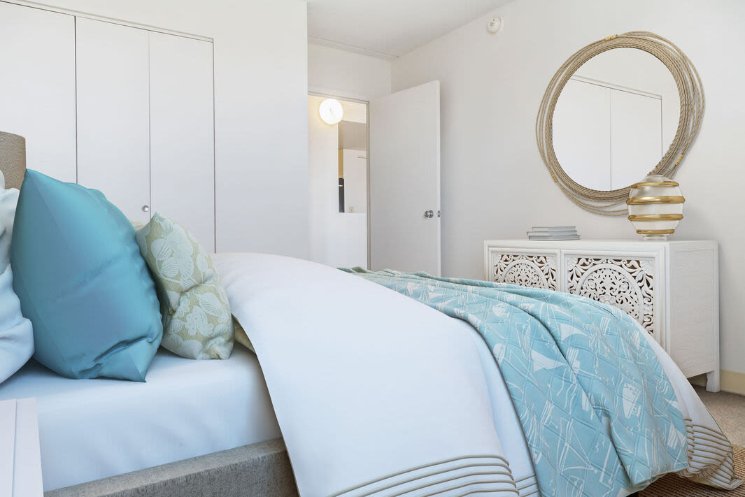 Bedroom with a bed and a mirror at Anchors Weigh in Chelsea, Massachusetts