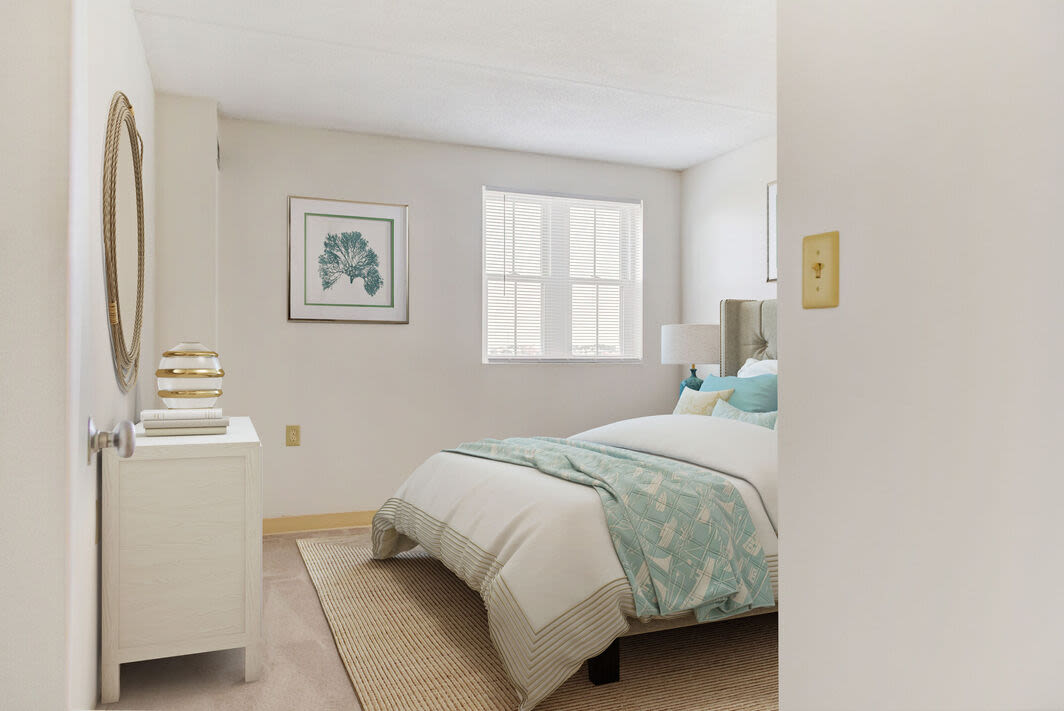 Cozy bedroom with a comfortable bed at Anchors Weigh in Chelsea, Massachusetts