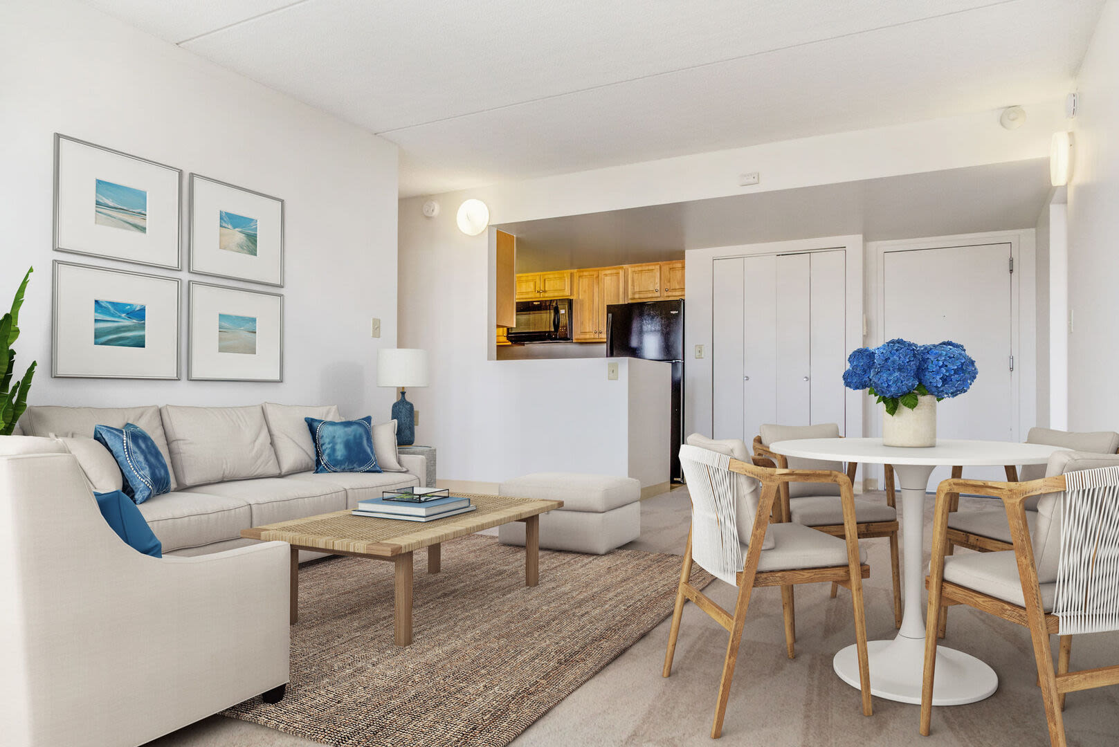 View of the living room and the dining area with a table and chairs at Anchors Weigh in Chelsea, Massachusetts