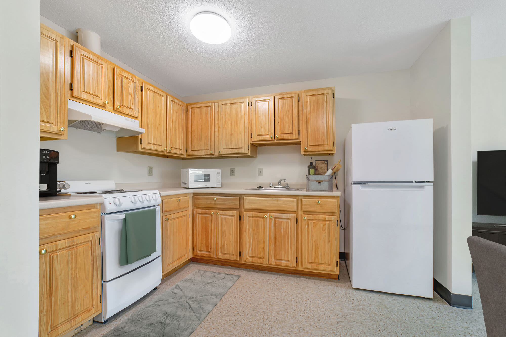 Modern kitchen with wooden cabinets at John Boyle O'Reilly Apartments in South Boston, Massachusetts