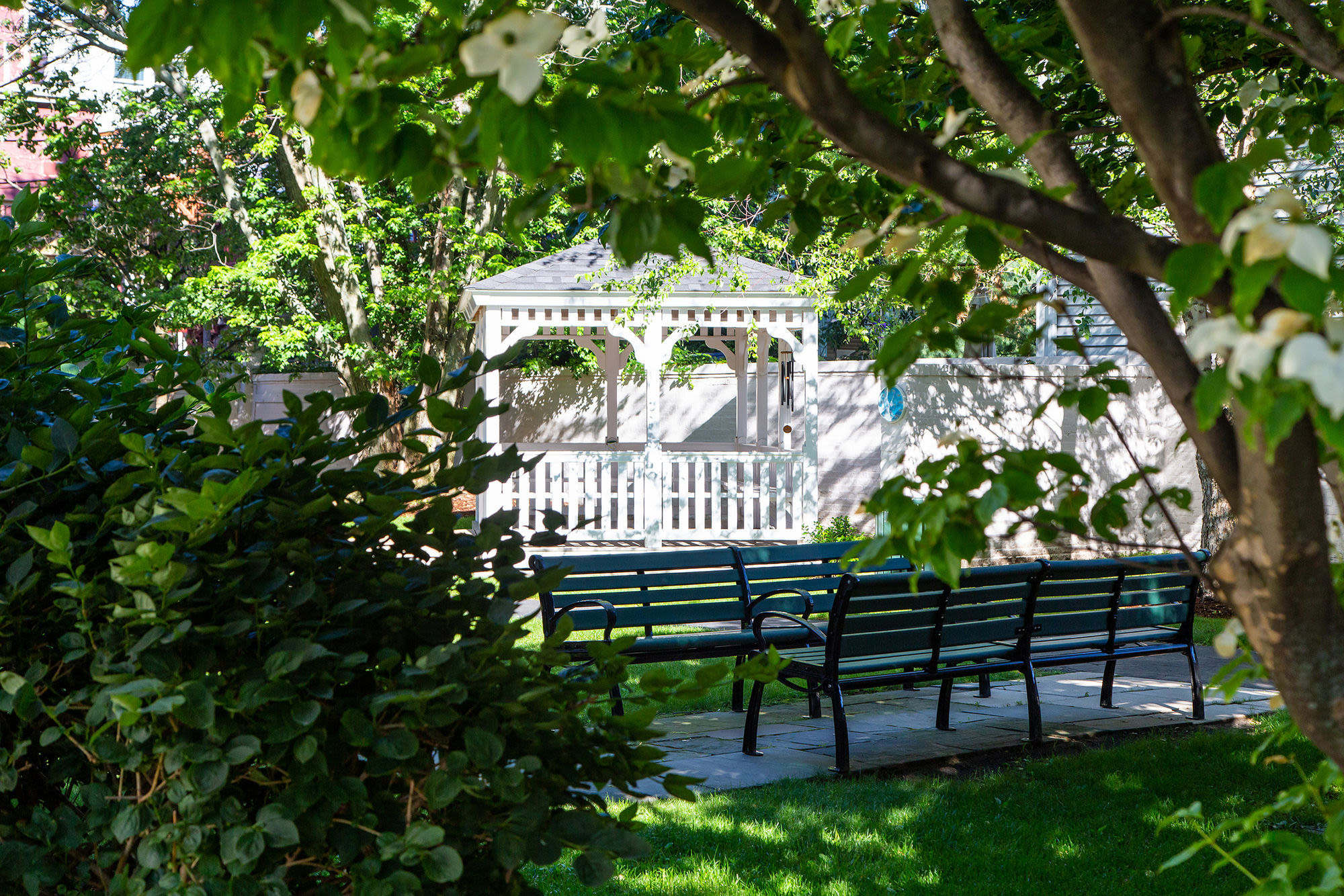 Park bench under trees at John Boyle O'Reilly Apartments in South Boston,Massachusetts