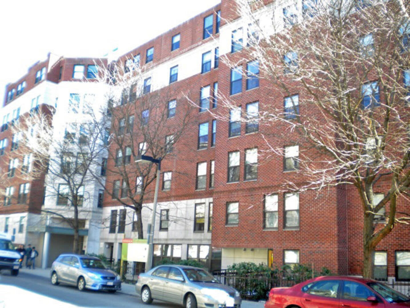  Exterior view of the apartment building with many windows and trees in front at Peterborough Apartments in Boston, Massachusetts