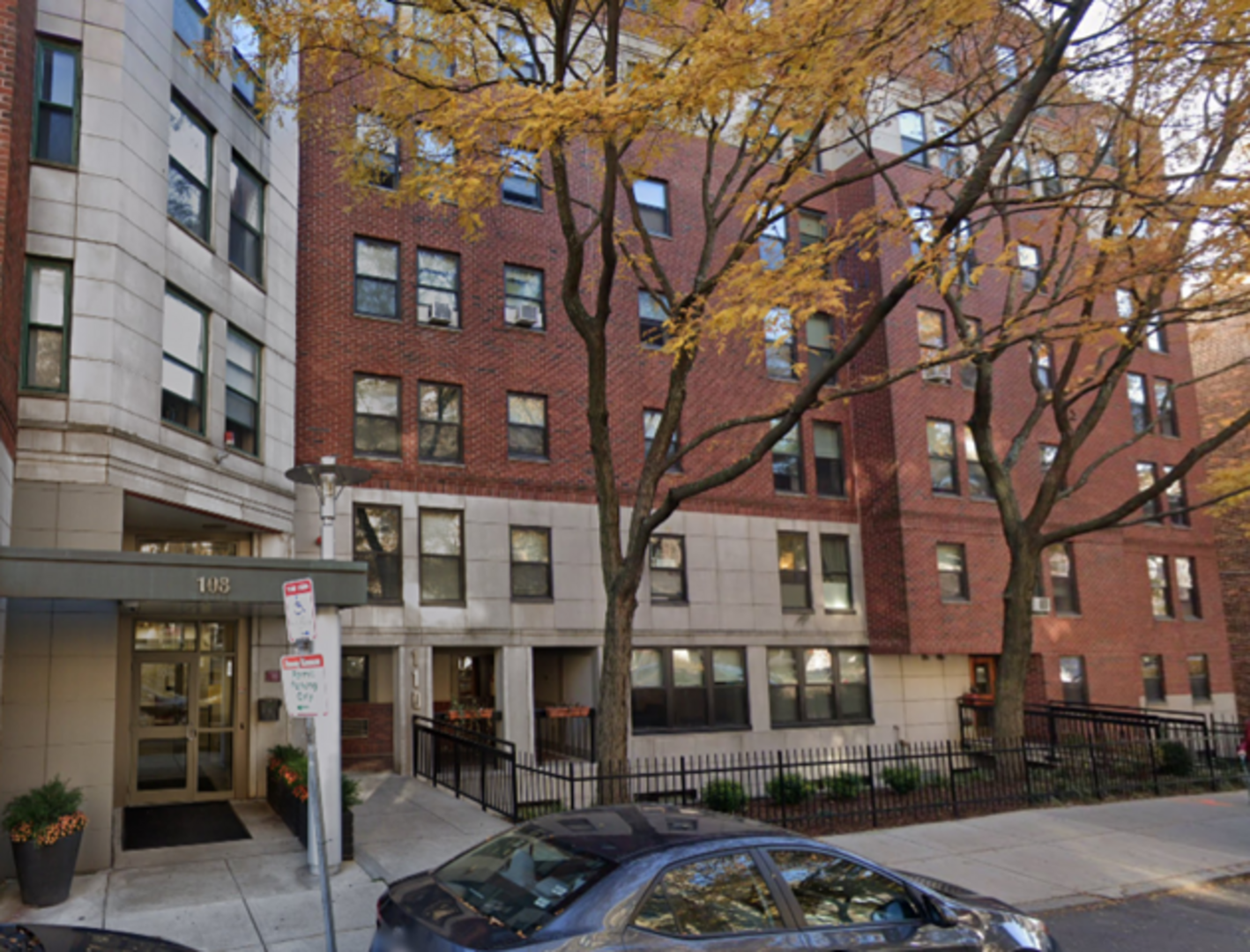 Apartment building with multiple windows and cars parked in front at Peterborough Apartments in Boston, Massachusetts