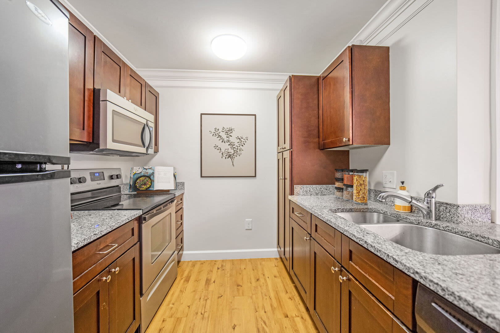 Kitchen with walnut color cabinet at Sterling Place in Lakeville, Massachusetts