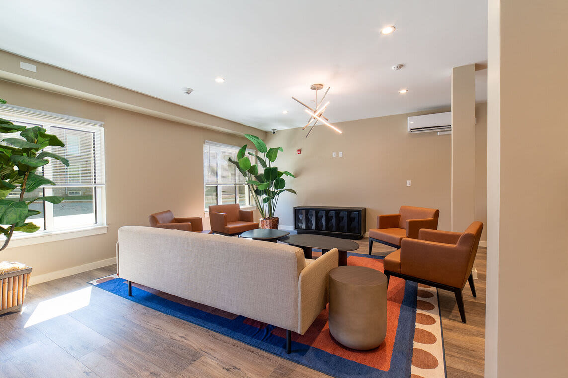 Club house waiting room with couch and more at Solara in Tiverton, Rhode Island