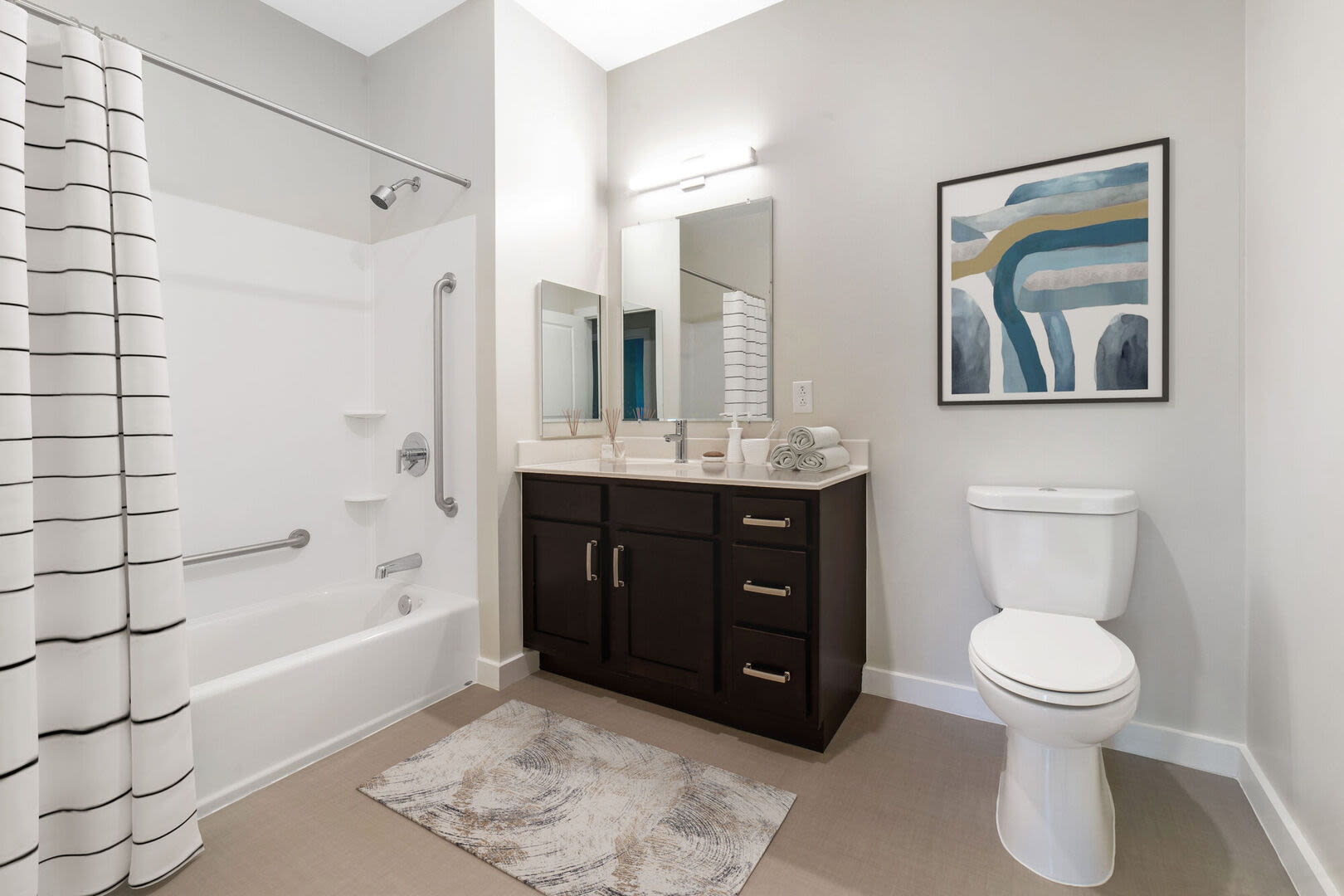 Bright bathroom with sink, tub and storage space at Solara in Tiverton, Rhode Island