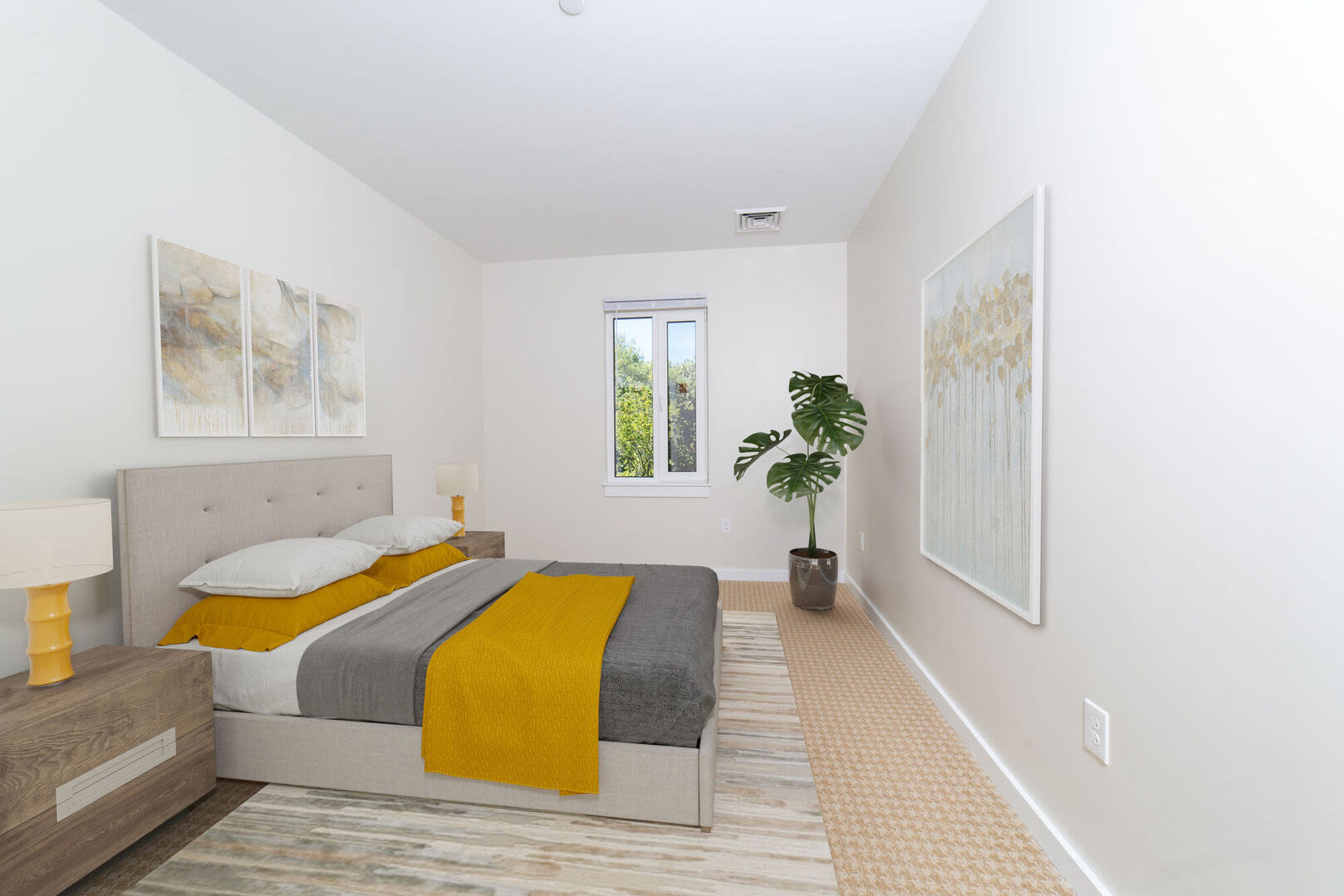 Cozy bedroom with window and a plant at Solara in Tiverton, Rhode Island