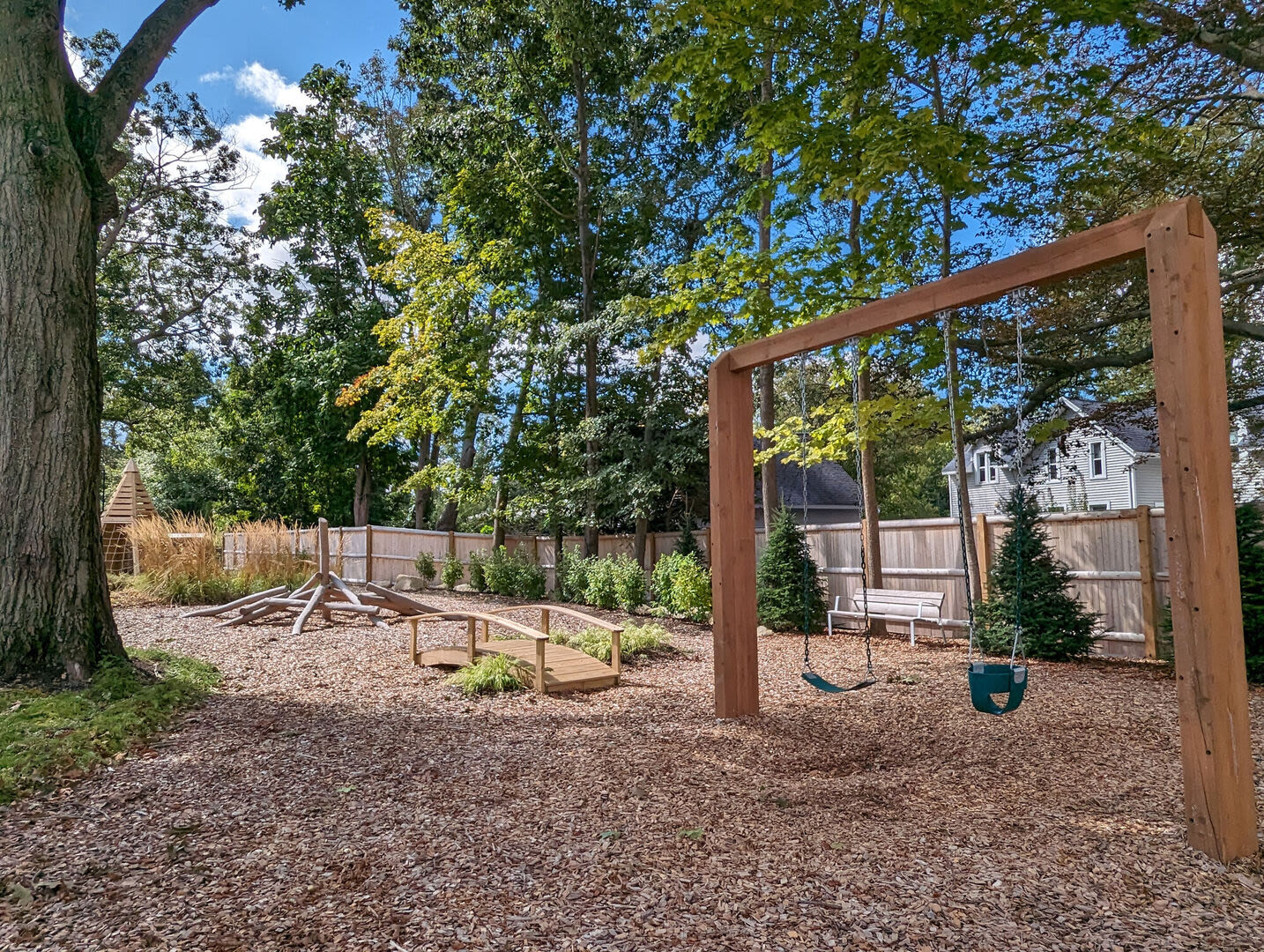 Kids play area with a swing at The Mcelwain School Apartments in Bridgewater,Massachusetts