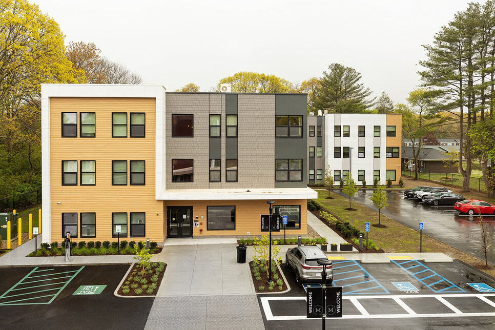 View of the building with car parking at The Mcelwain School Apartments in Bridgewater,Massachusetts