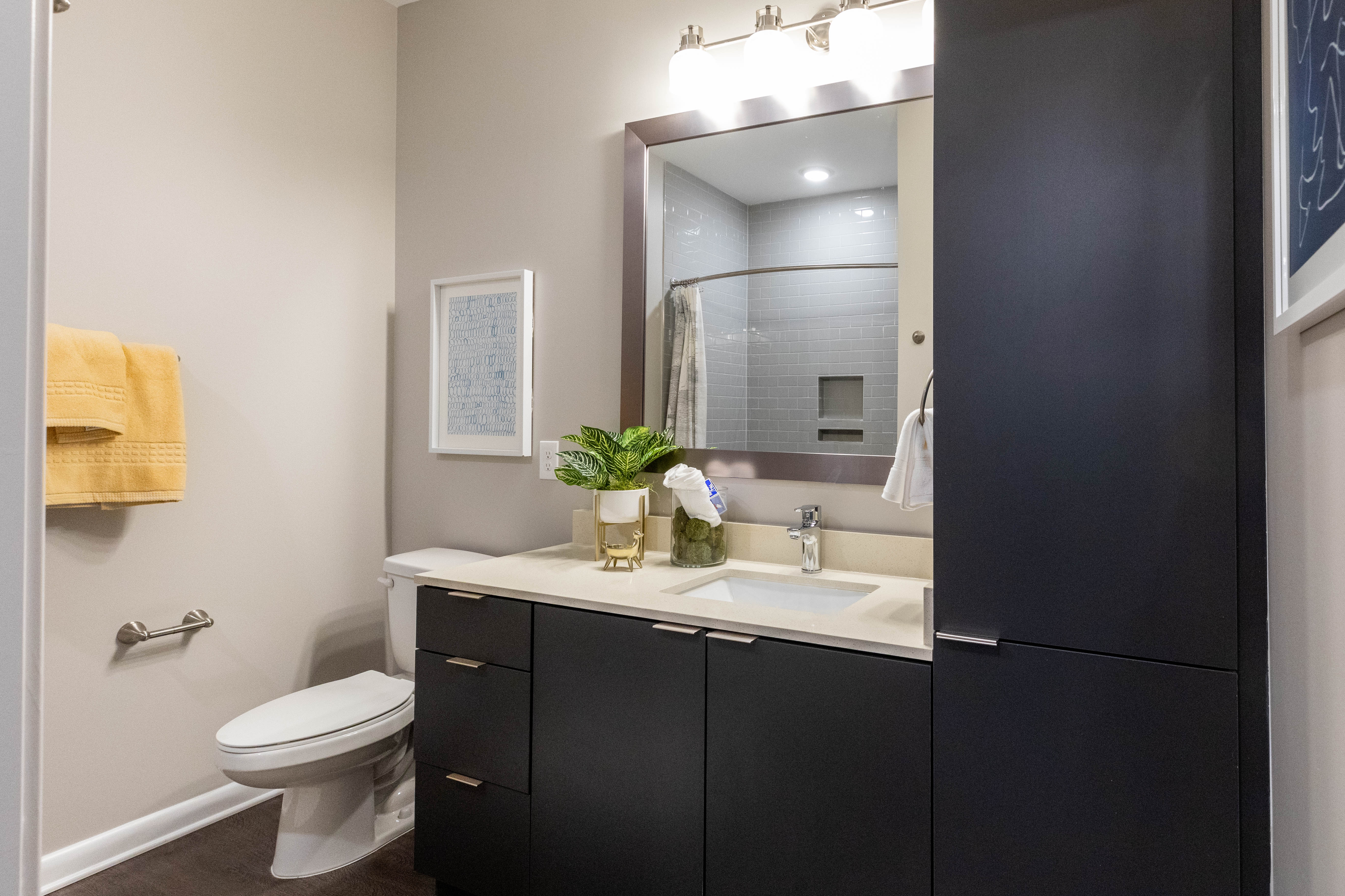 Model bathroom with dark accents The Jade at Avondale in Decatur, Georgia