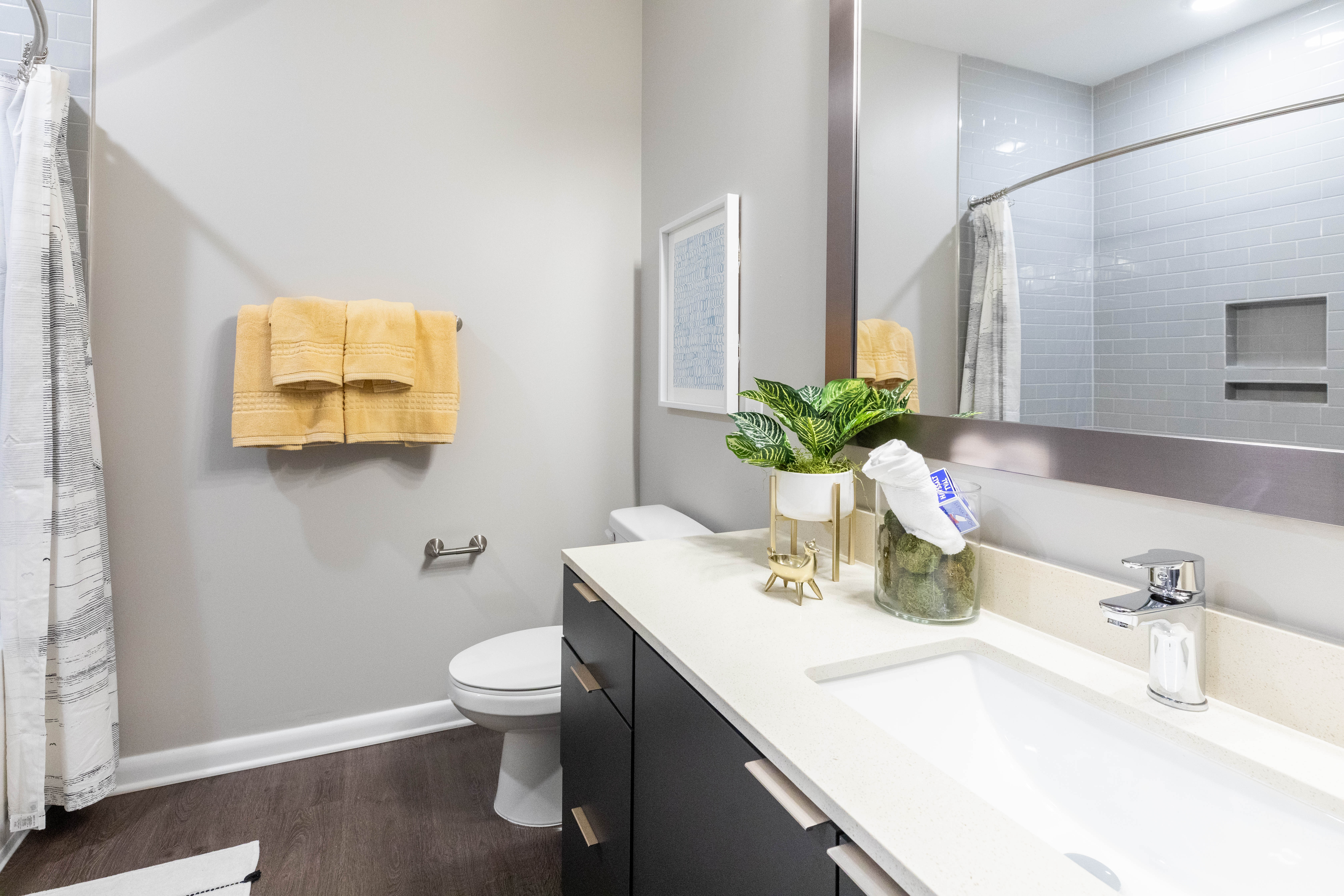 Model bathroom with wood flooring The Jade at Avondale in Decatur, Georgia
