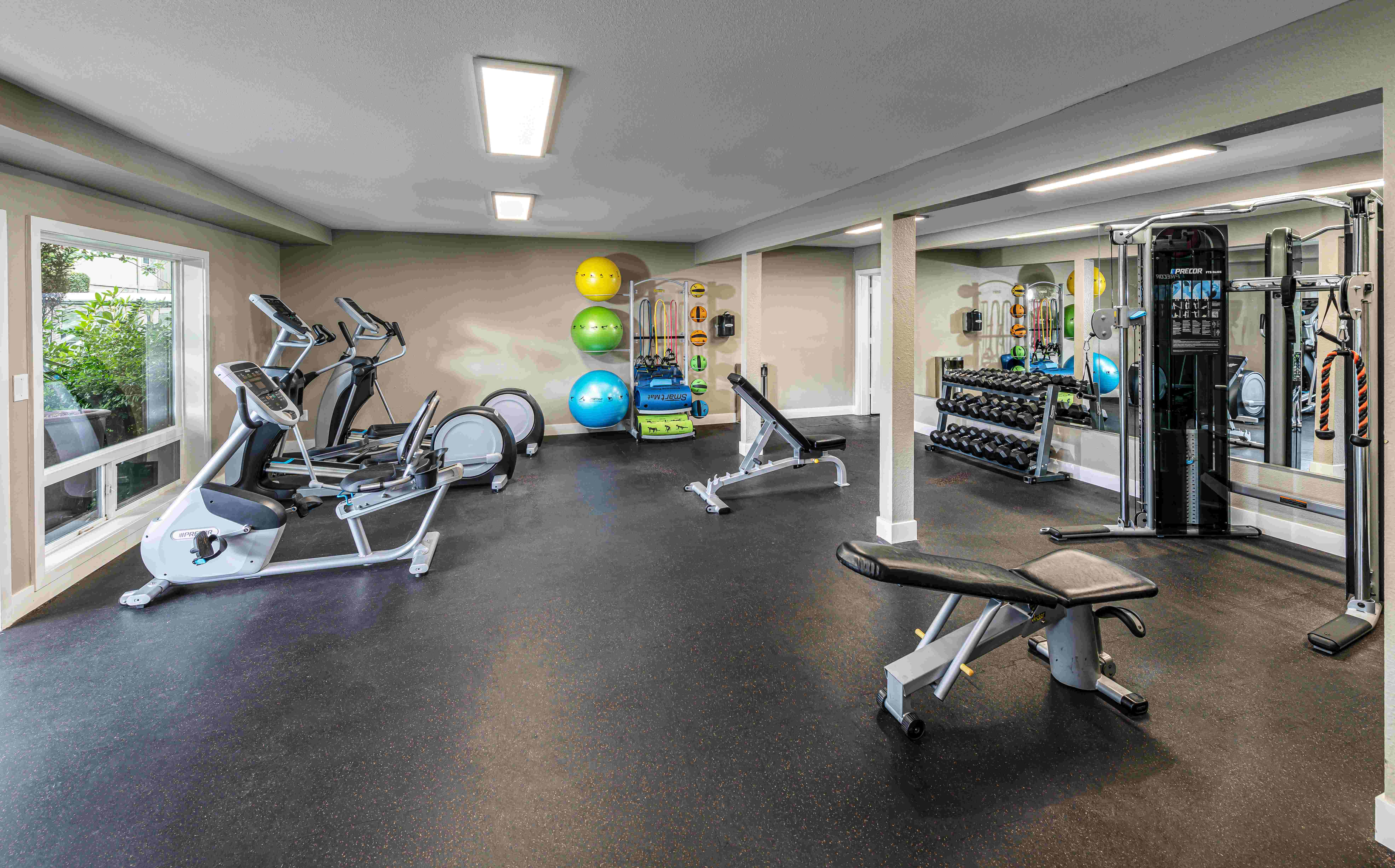 Fitness center with equipment at Alder Bellevue in Bellevue, Washington