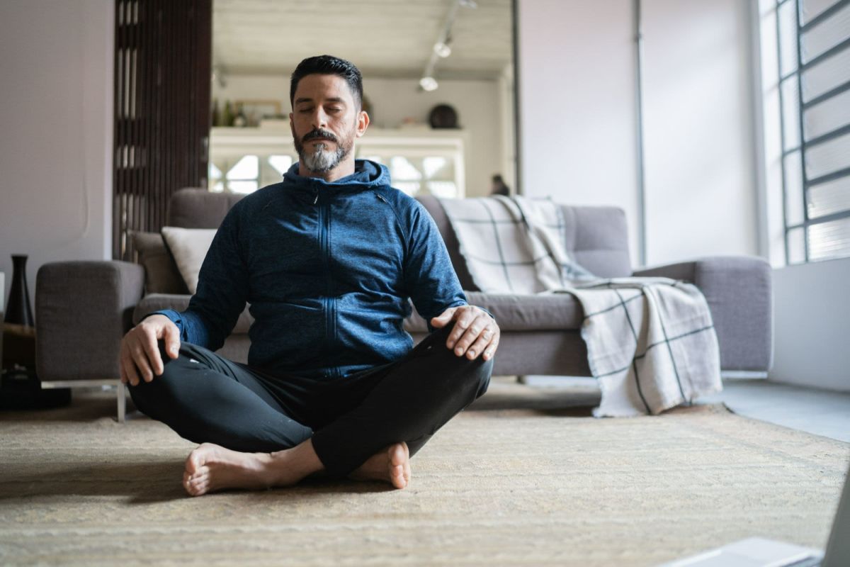 A resident meditating and feeling safe in his apartment at Villa Careena, West Hollywood, California
