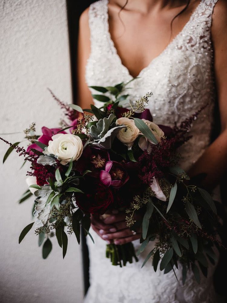 Bride with flowers at The Whitcomb Senior Living Tower in St. Joseph, Michigan