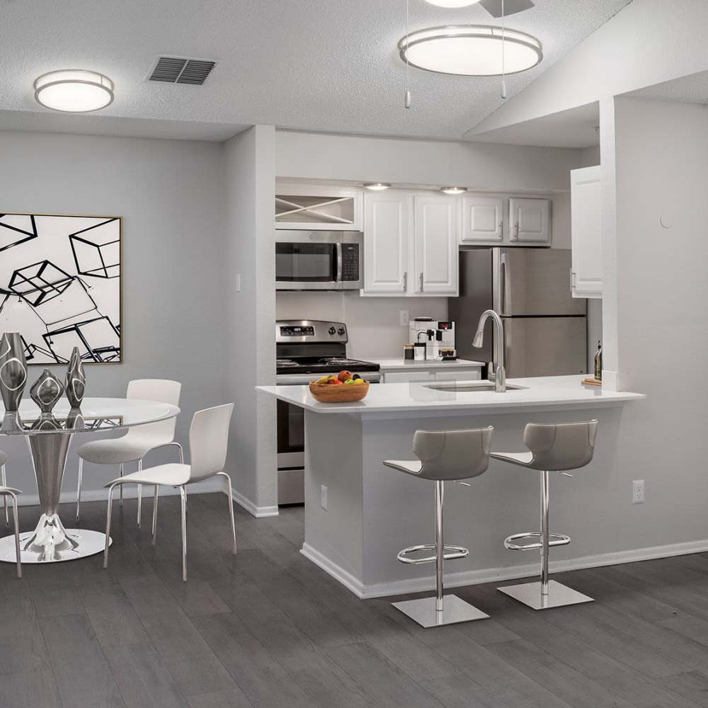 Kitchen with a breakfast bar and wood-style flooring at The Edge at Lake Lotus in Altamonte Springs, Florida