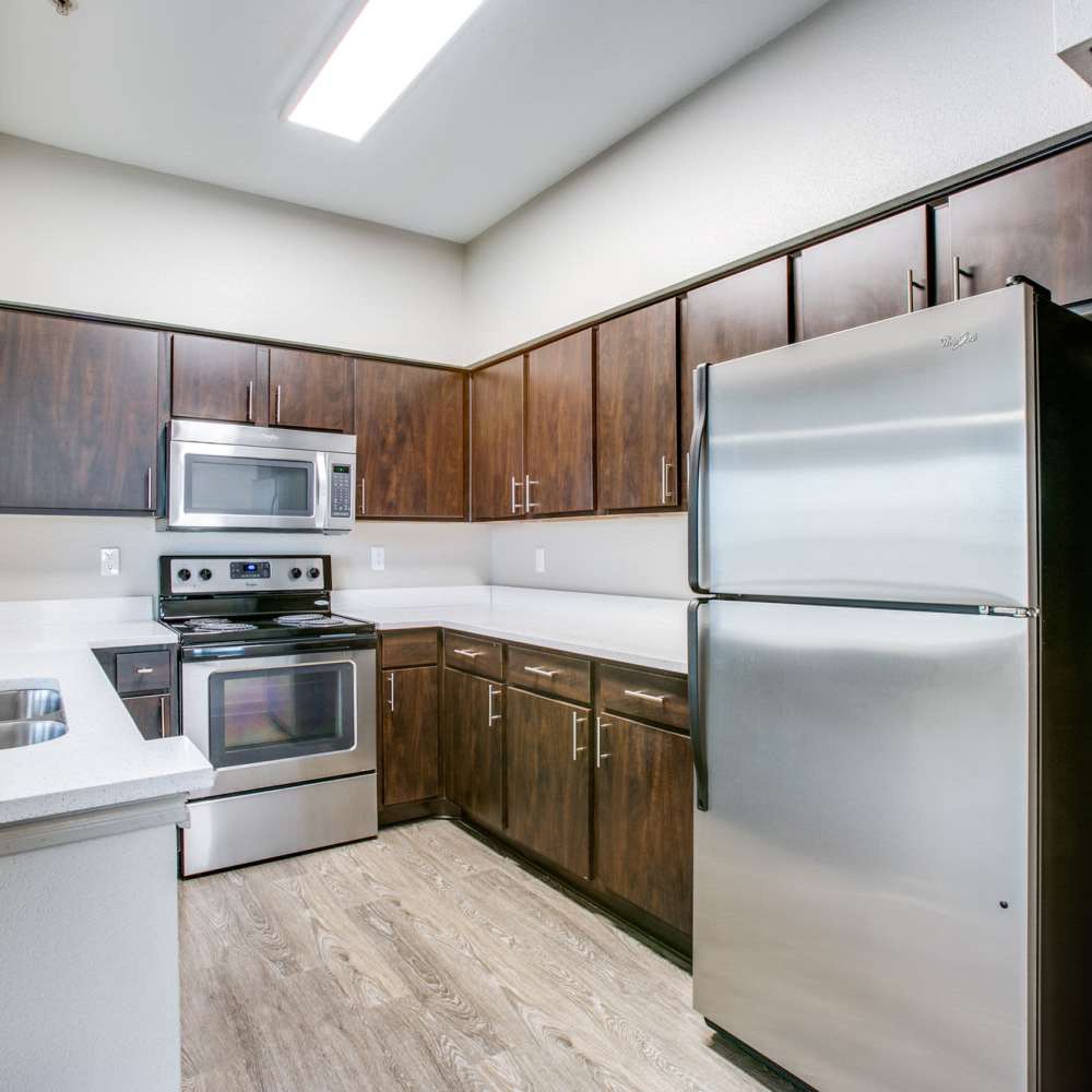 Kitchen with wood-style flooring at Woodland Park in Houston, Texas