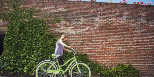 Resident walking her bike near Orchard City Lofts in Campbell, California
