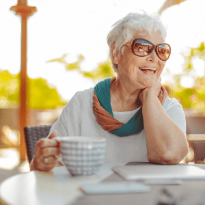 Resident enjoying a cup of coffee outside at Sunstone Village in Denton, Texas.