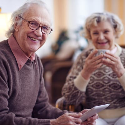 Residents smiling together over coffee at Towerlight in St. Louis Park, Minnesota