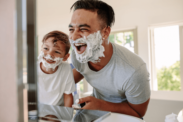 Father and son having fun while shaving in bathroom at Onnix in Tempe, Arizona