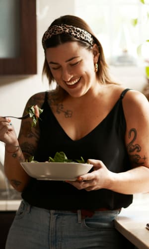 Resident enjoying a fresh meal in her kitchen at Pecan Ridge in Midlothian, Texas