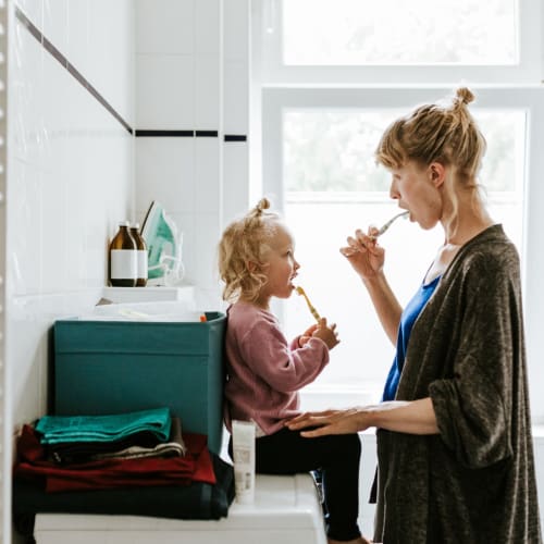 a mother and daughter brushing their teeth together at Santa Rosa in Point Mugu, California