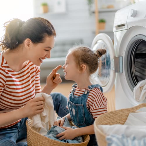a resident doing laundry with her daughter at Shadow Mountain in Twentynine Palms, California
