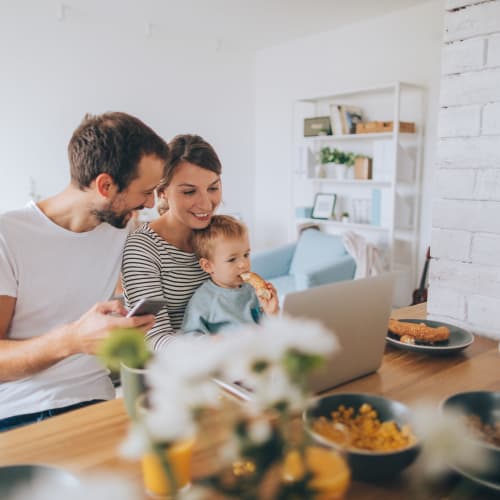 a family looking at a laptop at Home Terrace in San Diego, California