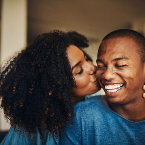 a resident kissing partners cheek at Riverview Village in Indian Head, Maryland