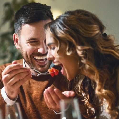 a resident spoon feeding his partner at Riverview Village in Indian Head, Maryland