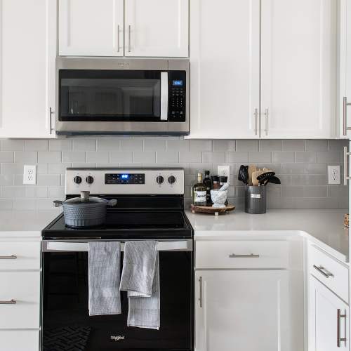 Kitchen with stainless-steel appliances in a furnished model home at The Station at Fleming Island in Fleming Island, Florida