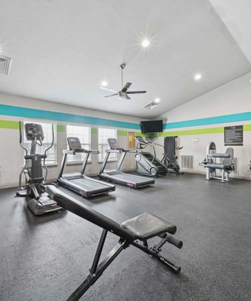Gym Interior With Exercise Equipment And Colorful Walls at Lighthouse Landings in Indianapolis, Indiana