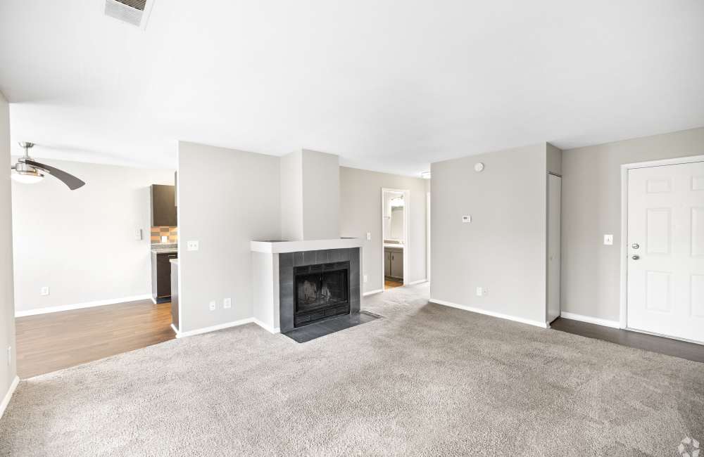 living room with wall to wall carpeting and fireplace at Mad River Apartment Homes in Dayton, Ohio