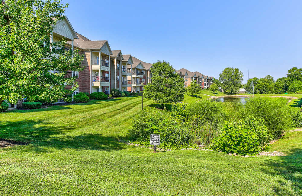 Exterior of apartment buildings with ample green space at Blankenbaker Crossings in Louisville, Kentucky