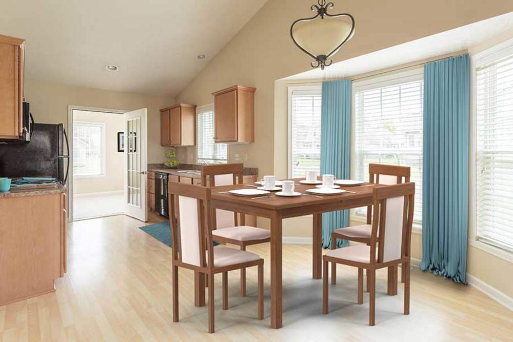 Beautiful model dining area and living room at Hickory Hollow in Spencerport, New York