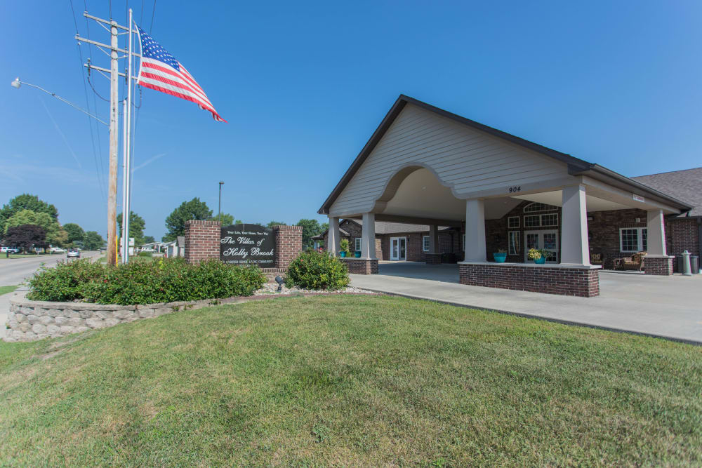Main entrance to Villas of Holly Brook Effingham with an american flag waving out front in Effingham, Illinois