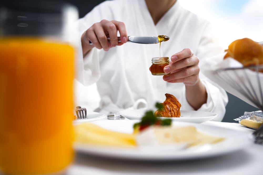 Chef toping off a meal at Claremont Place in Claremont, California